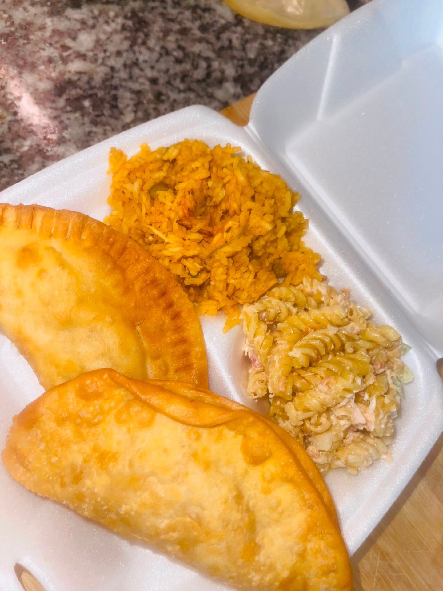 Catering trays of empanadas, arroz con gandules and antipasta salad